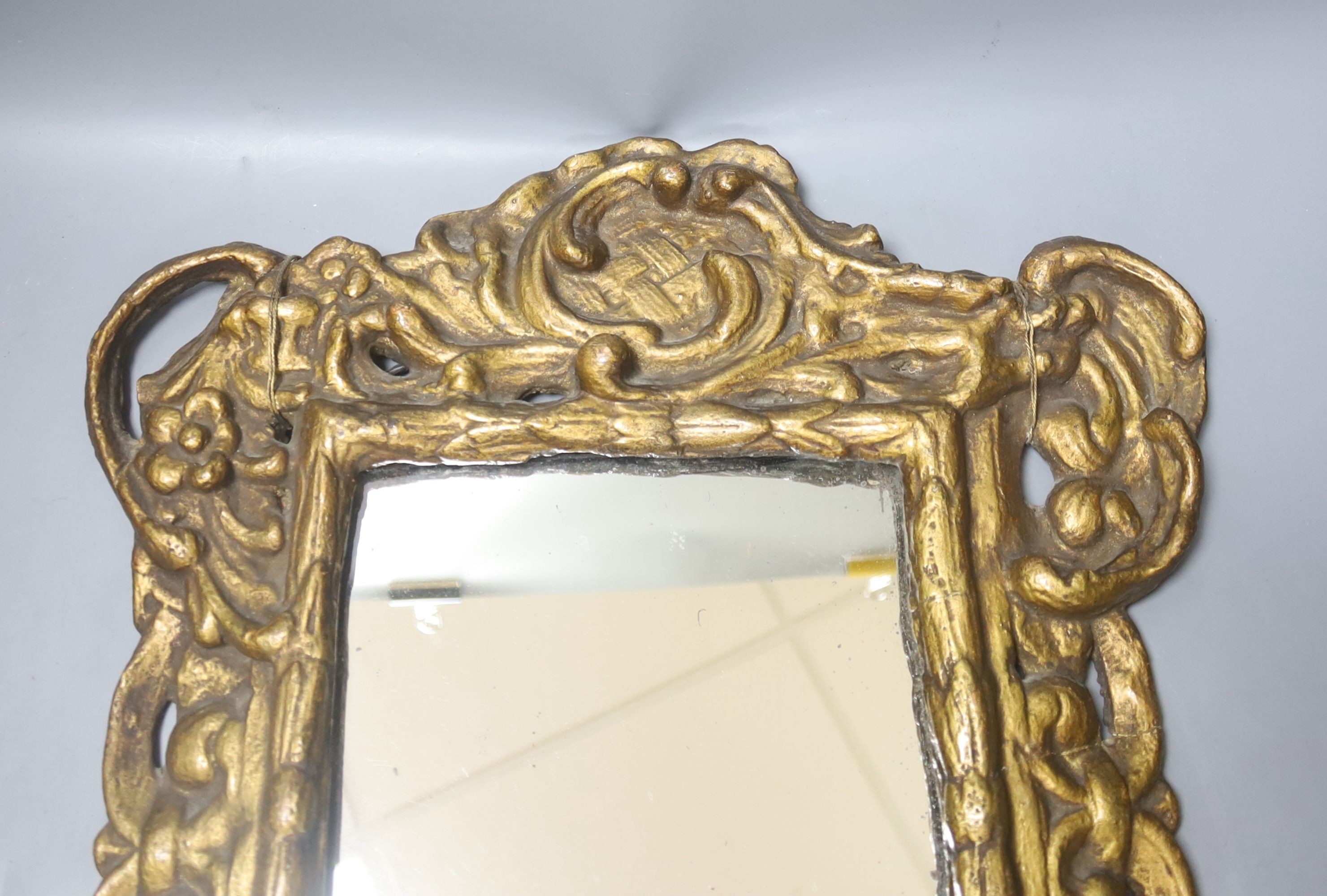 A 19th century gilt composition rectangular mirror in the Baroque style